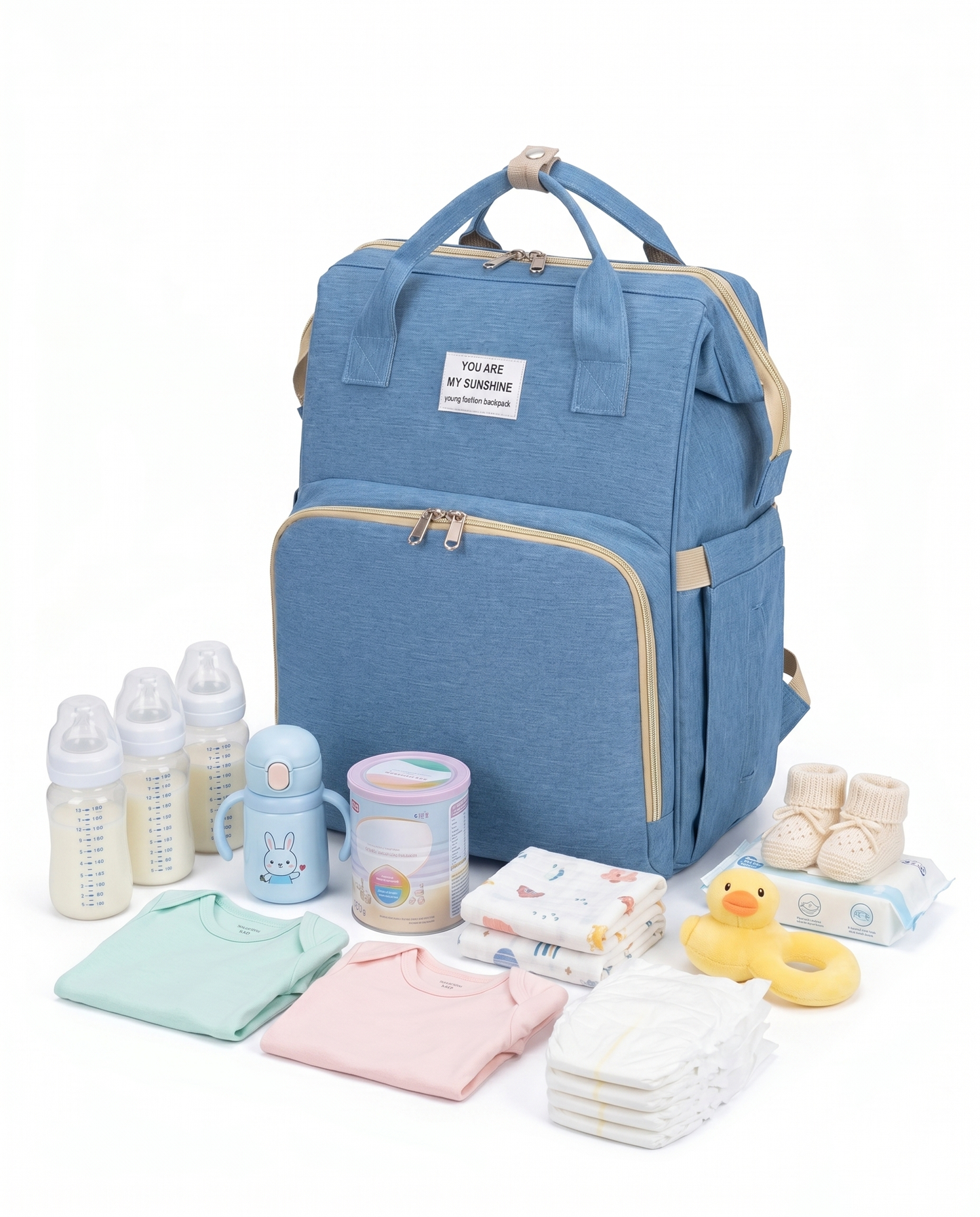 Sky blue baby diaper backpack displayed with nappies, bottles, formula, baby clothes and wipes