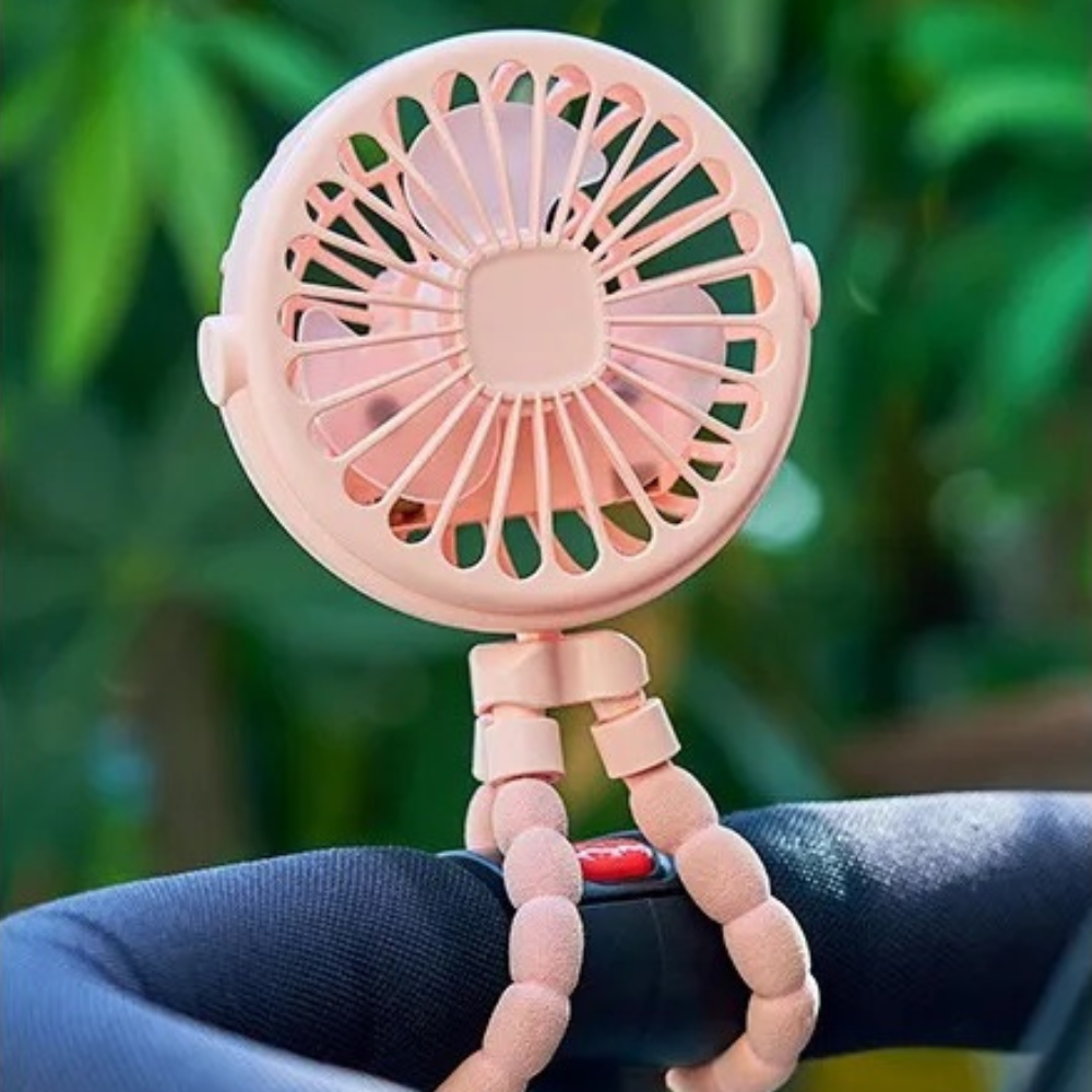 Pink stroller fan with flexible tripod legs attached to baby stroller handlebar.