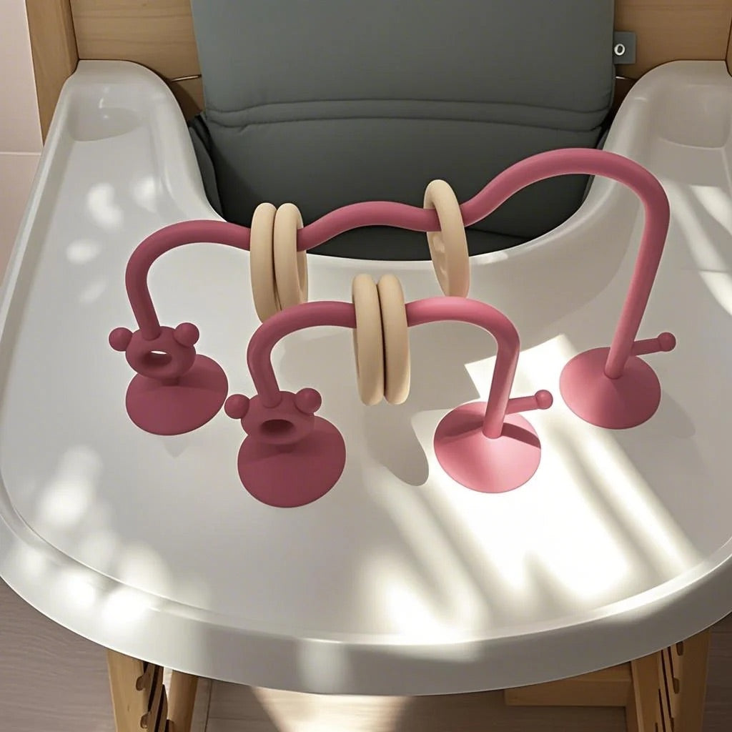 Silicone bead maze toy on feeding chair tray during mealtime.