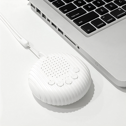 USB rechargeable white noise machine connected to laptop for convenient charging