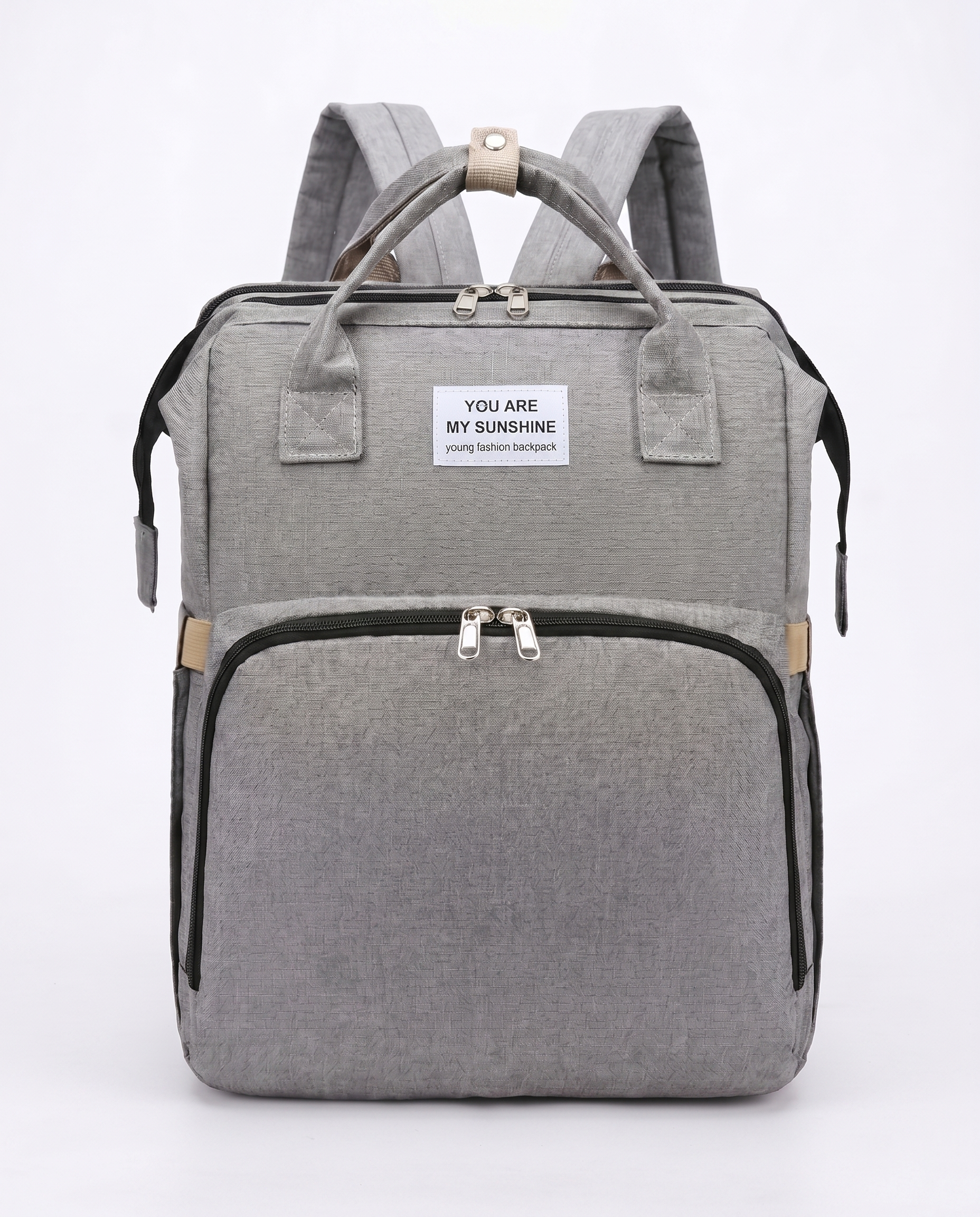 Grey foldable baby diaper backpack with carry handles, large front pocket and beige zip detail