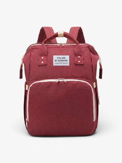 Red 3-in-1 diaper bag backpack with foldable baby bed and changing station | Early Nest