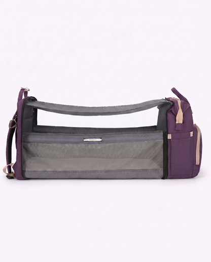 Purple baby diaper backpack unfolded into portable travel bassinet cot