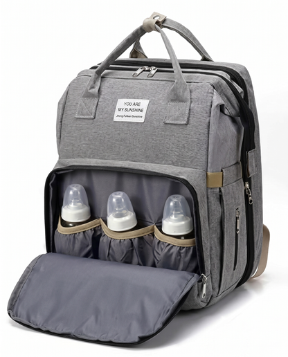 Grey baby nappy backpack with open front pocket holding three insulated baby feeding bottles