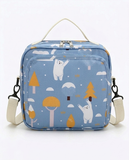 Baby nappy bag blue polar bear print with cream canvas strap and dual zip closure on white background