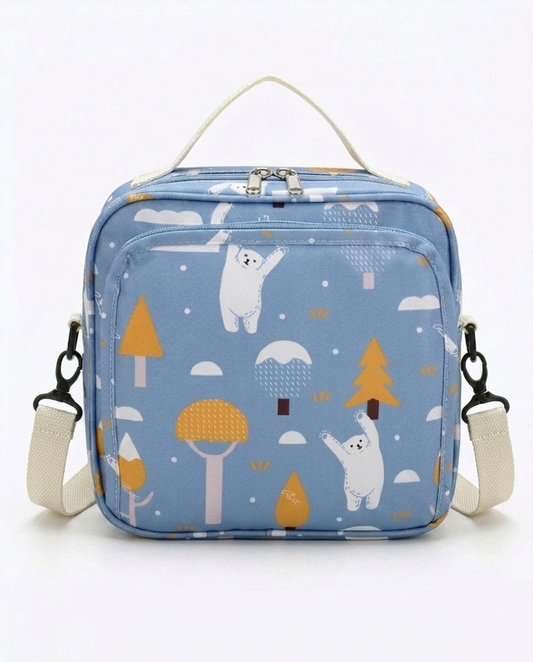 Baby nappy bag blue polar bear print with cream canvas strap and dual zip closure on white background