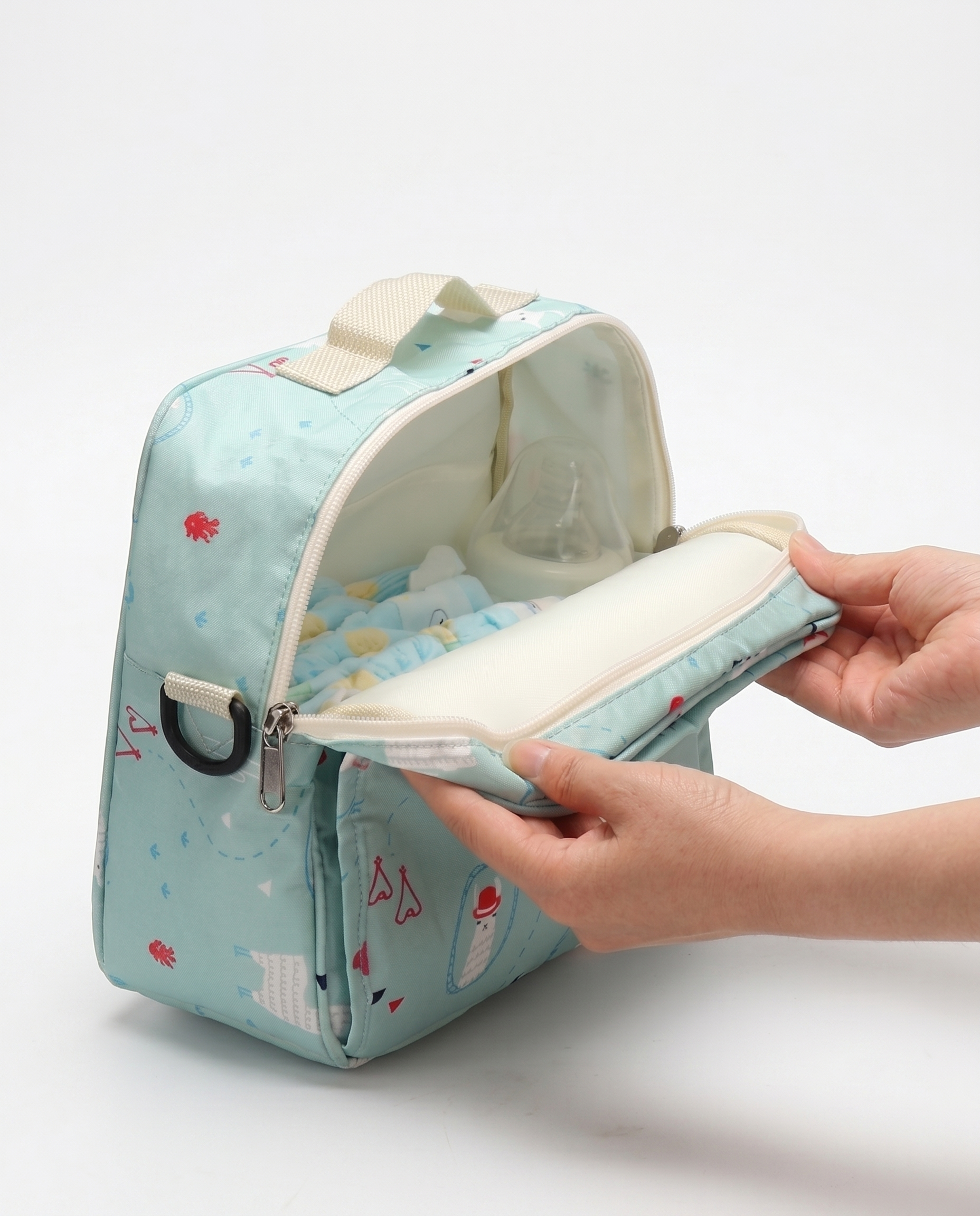 Nappy bag open showing removable changing mat insert and nappies fitted inside