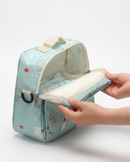 Nappy bag open showing removable changing mat insert and nappies fitted inside